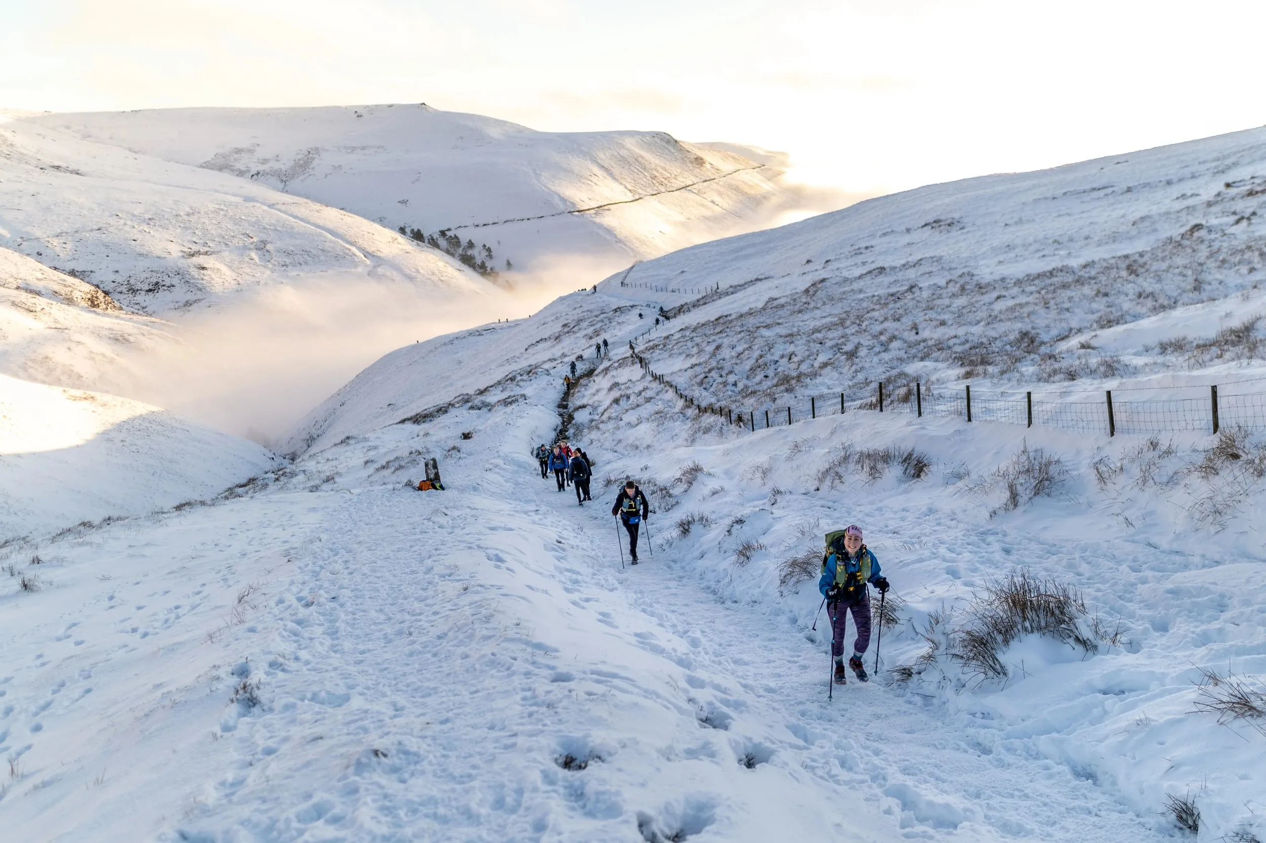 Runners on a snow-covered trail during The Spine Race